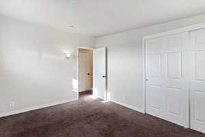 Unfurnished bedroom featuring carpet floors and a closet
