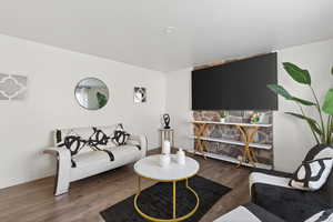 Living area with wood finished floors and baseboards