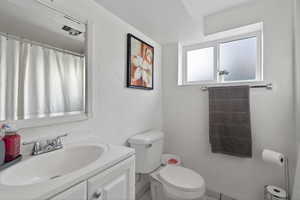 Bathroom with vanity, curtained shower, and a textured wall