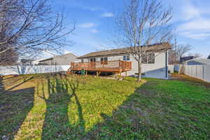 Back of house with a wooden deck