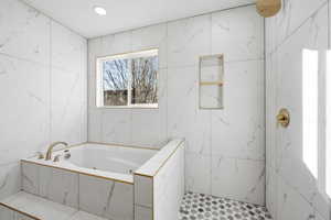 Bathroom featuring a marble finish shower, a whirlpool tub, and recessed lighting