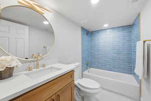 Full bath featuring  shower combination, vanity, recessed lighting, and light tile patterned floors