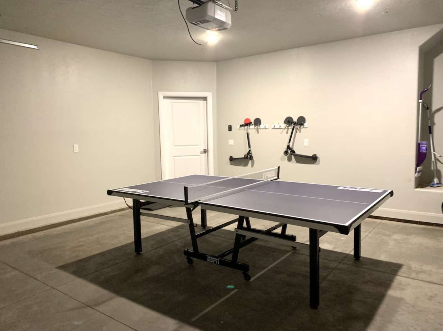 Game room featuring concrete flooring and baseboards
