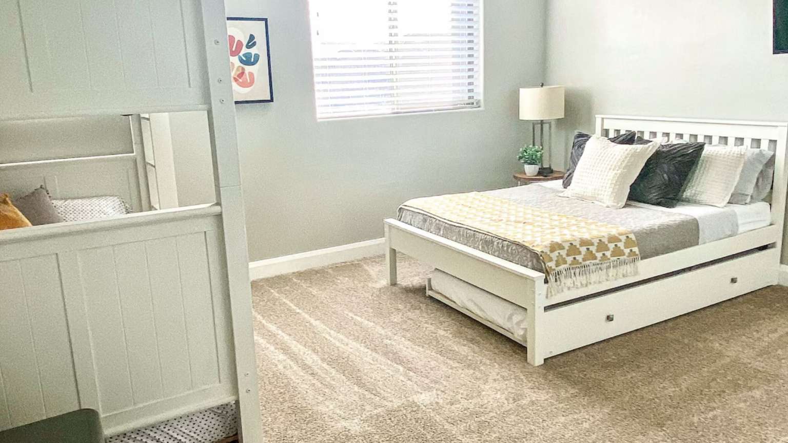 Bedroom featuring carpet floors and baseboards