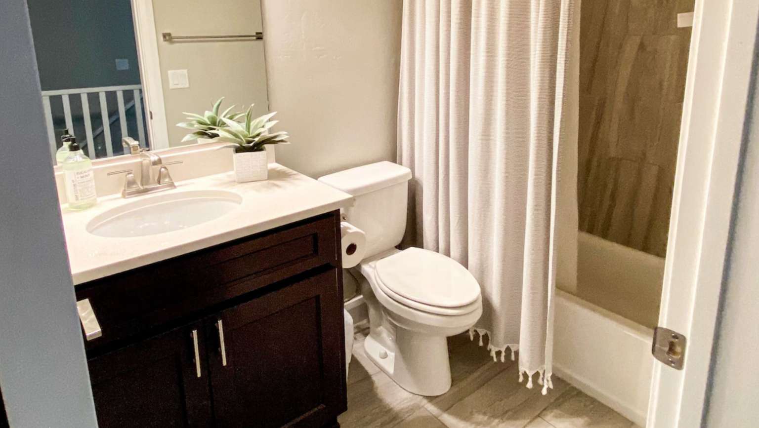 Bathroom with vanity and shower / bathtub combination with curtain