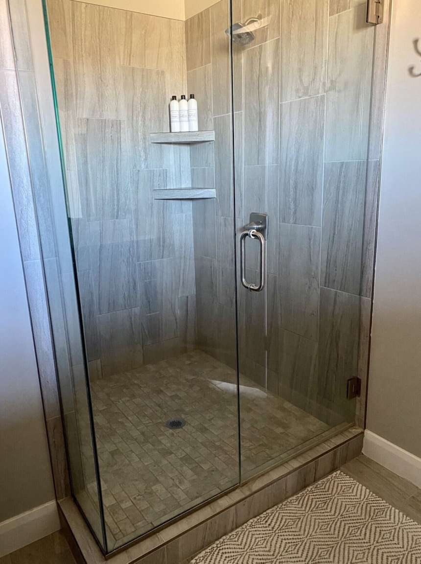 Bathroom with a stall shower and wood finished floors