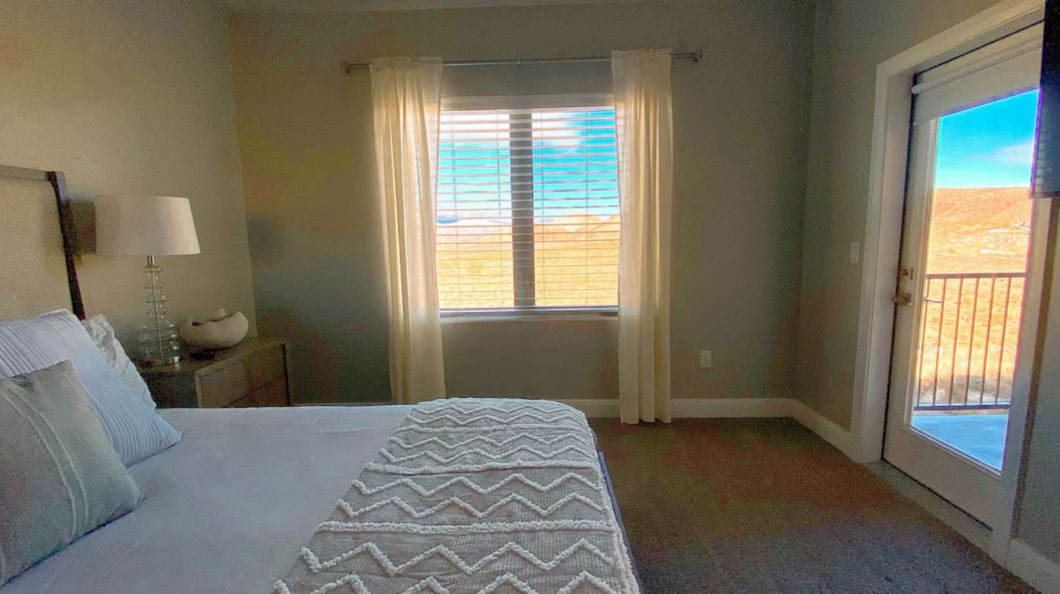 Bedroom with access to exterior and dark carpet