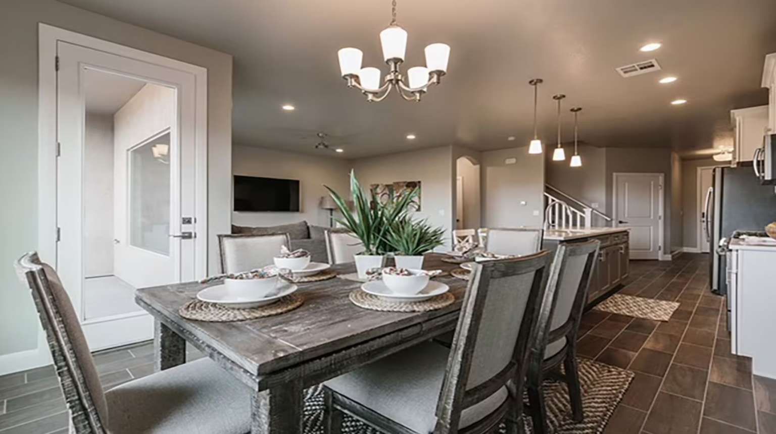 Dining space with wood finish floors, recessed lighting, stairway, and a chandelier