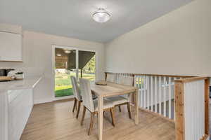 Dining room featuring light wood-style flooring and a textured ceiling