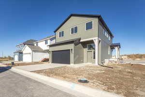 View of front of house featuring an attached garage and driveway