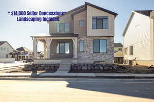 View of front facade with stone siding and covered porch
