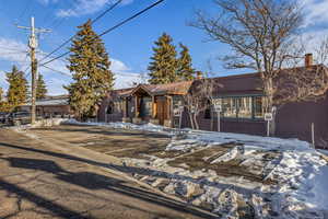 View of front facade featuring a chimney