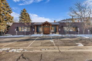 View of building exterior with uncovered parking