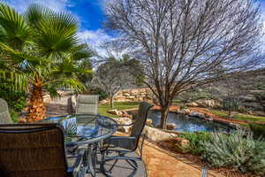 View of patio / terrace with a small pond and outdoor dining space