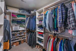 Primary Bedroom Walk in closet with carpet