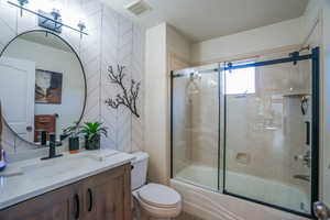 Bathroom #2 with vanity and bath / shower combo with glass door