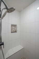 Bathroom featuring a professionally tiled shower
