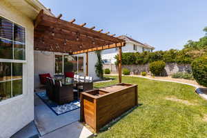 Fenced backyard with a pergola, an outdoor living space, a patio area, and outdoor dining space