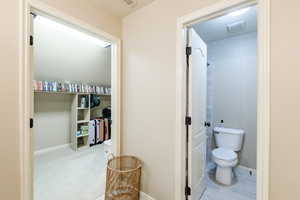 Bathroom featuring baseboards and toilet
