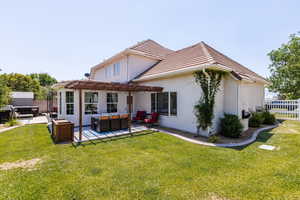 Back of house with an outdoor living space, a pergola, stucco siding, and a patio