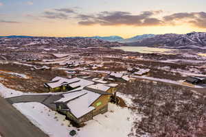 Snowy aerial view featuring a mountain view and a residential view