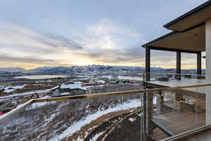 Snow covered back of property featuring a mountain view
