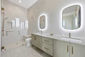 Bathroom with double vanity, a marble finish shower, and tile walls