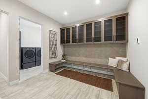 Mudroom with washer and dryer and wood tiled floors