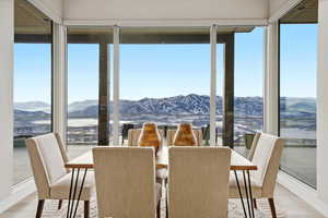 Sunroom / solarium with a mountain view and healthy amount of natural light
