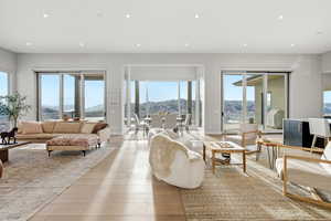 Living area with plenty of natural light, recessed lighting, light wood-style flooring, and a mountain view