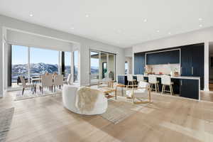 Living area featuring light wood-type flooring, recessed lighting, a mountain view, and bar area