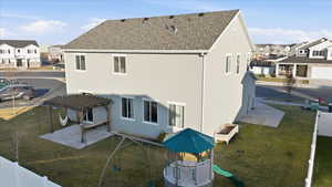Back of property featuring a residential view, a lawn, and a pergola