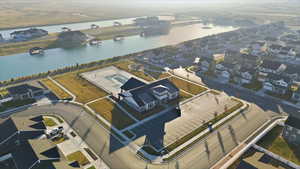 Aerial view of residential area featuring a nearby body of water