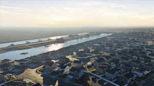 Aerial view at dusk of a water view and a residential view