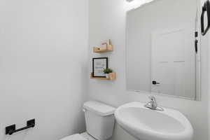 Bathroom featuring a sink and toilet