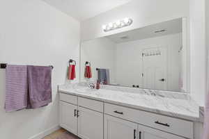 Bathroom with vanity, light tile patterned floors, and curtained shower