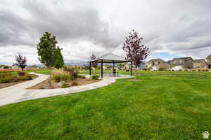 View of property's community with a gazebo, a patio area, and a yard