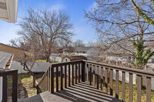 Wooden terrace with a residential view and an outdoor structure