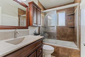 Bathroom with tiled shower / bath combo and vanity