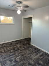 Unfurnished bedroom featuring a ceiling fan, new Lifeproof dark wood-type flooring, a closet, and a textured ceiling