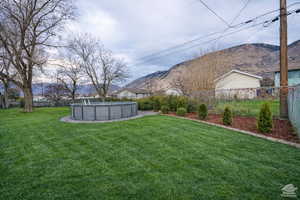 Fenced backyard with a mountain view