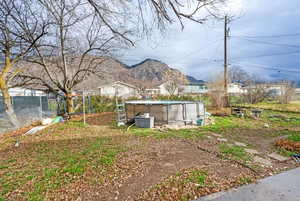 Fenced backyard featuring a mountain view