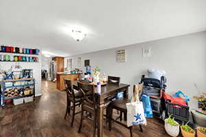 Dining room with dark wood-style flooring