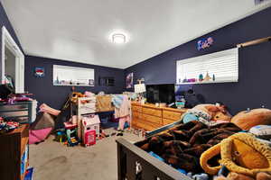 Carpeted bedroom featuring a textured ceiling