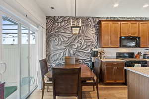 Dining space featuring light wood-style floors and recessed lighting