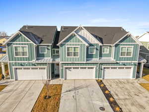 Craftsman house featuring board and batten siding, roof with shingles, driveway, an attached garage, and a residential view
