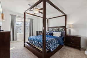 Bedroom featuring light carpet and a ceiling fan