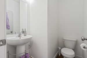 Bathroom featuring toilet and baseboards