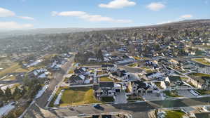 Aerial view of property and surrounding area with nearby suburban area