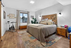 Bedroom featuring a barn door and light wood-style floors